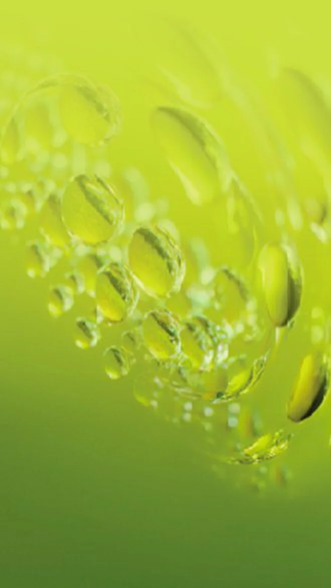 alt="Close-up of translucent gel bubbles and droplets against a lime green background, illustrating the lightweight gel texture of the Aquasource+ Electrolyte Dewy Gel."